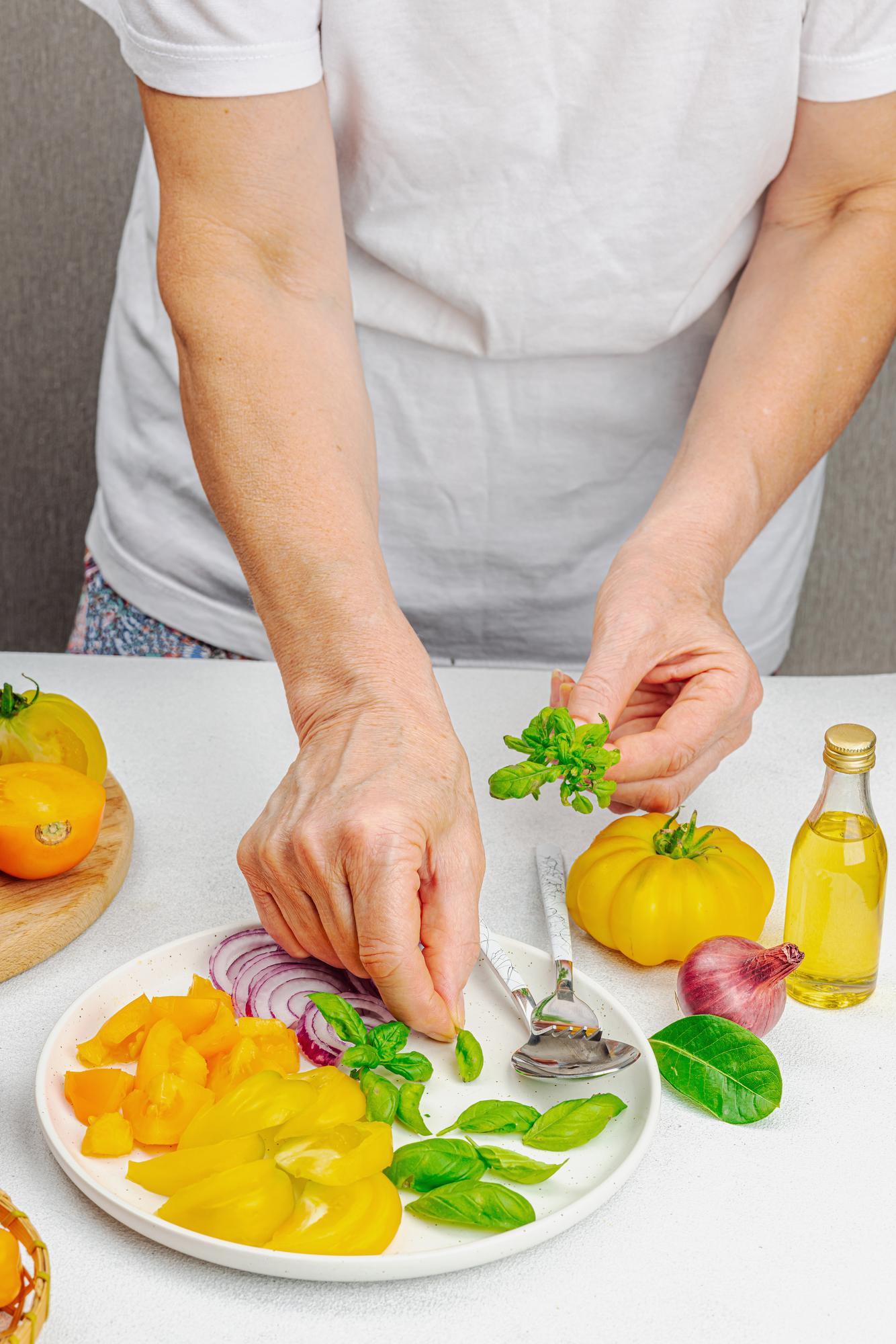 Hands preparing garnish in workshop